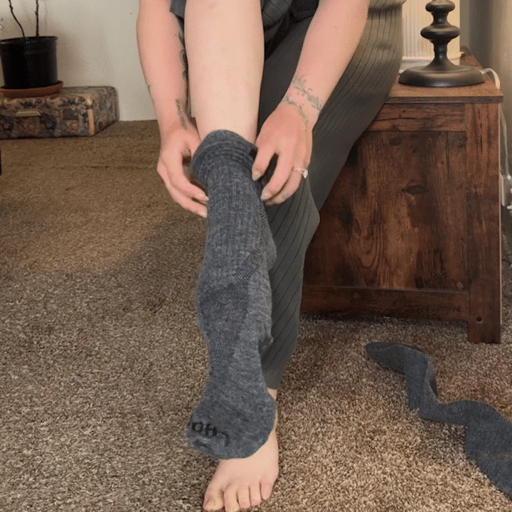 Picture of a girl putting compression socks on, showing how easy it is to slide on.