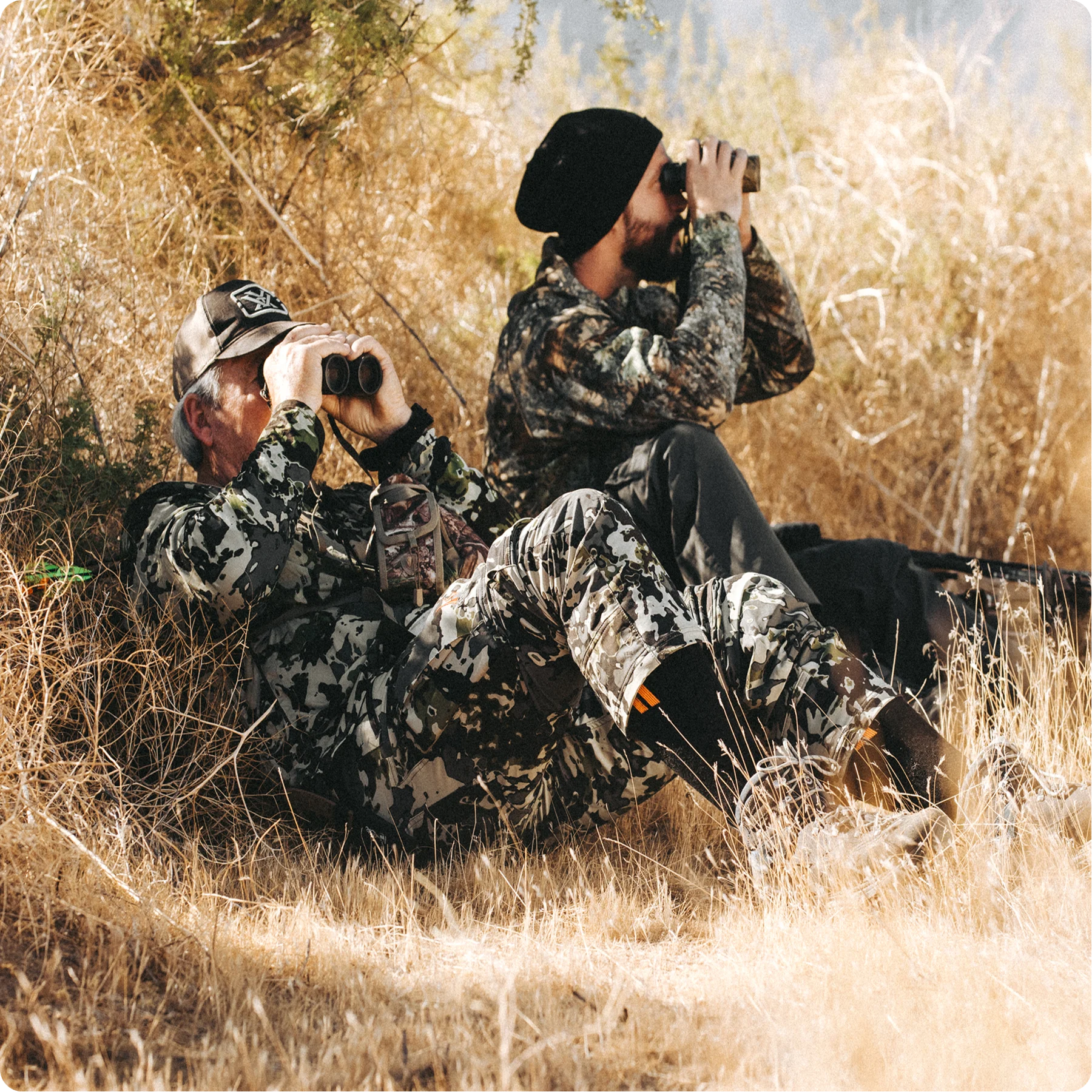 Two guys hunting while wearing Hollow Hunt socks.