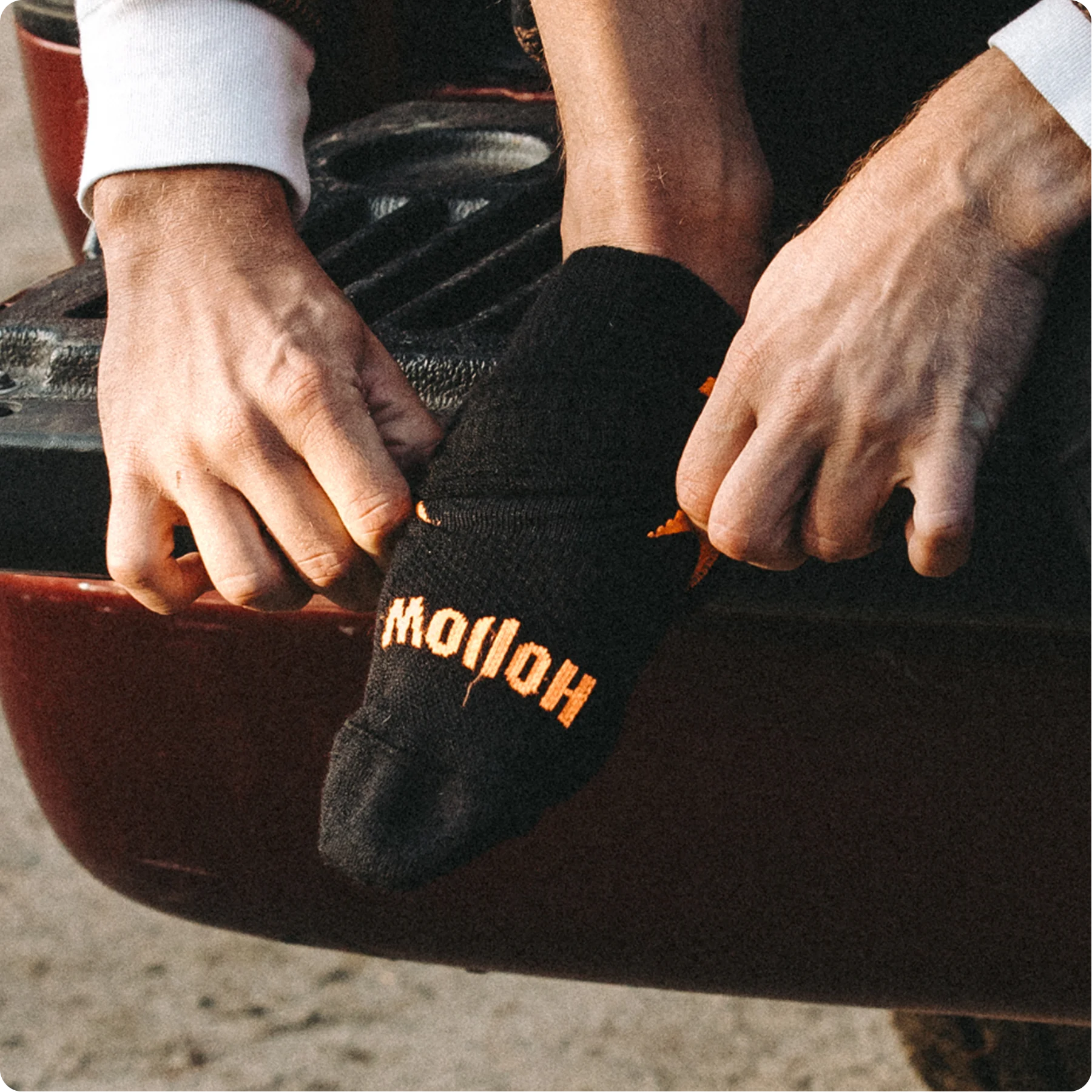 Guy putting Hunt socks showing how easy it is to put on